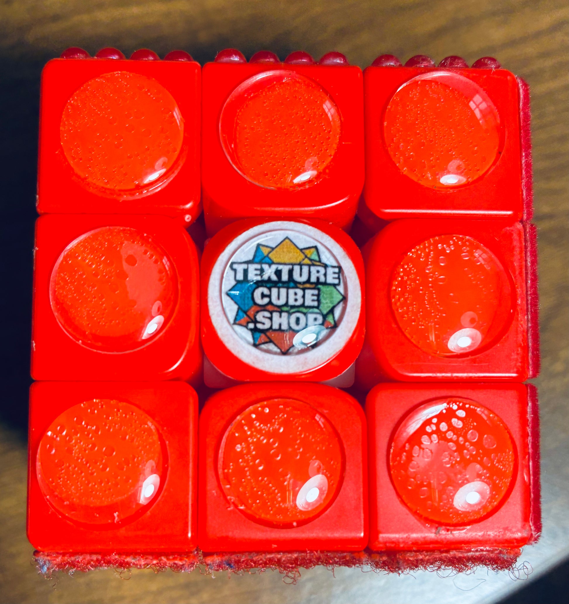 Close up of Rubik's cube side with red sphere in the center of each square